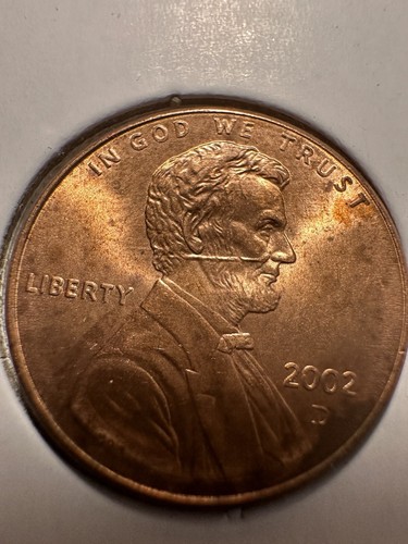 2002-D Lincoln penny die cap error showing cupped bowl shape with raised rims and distorted design