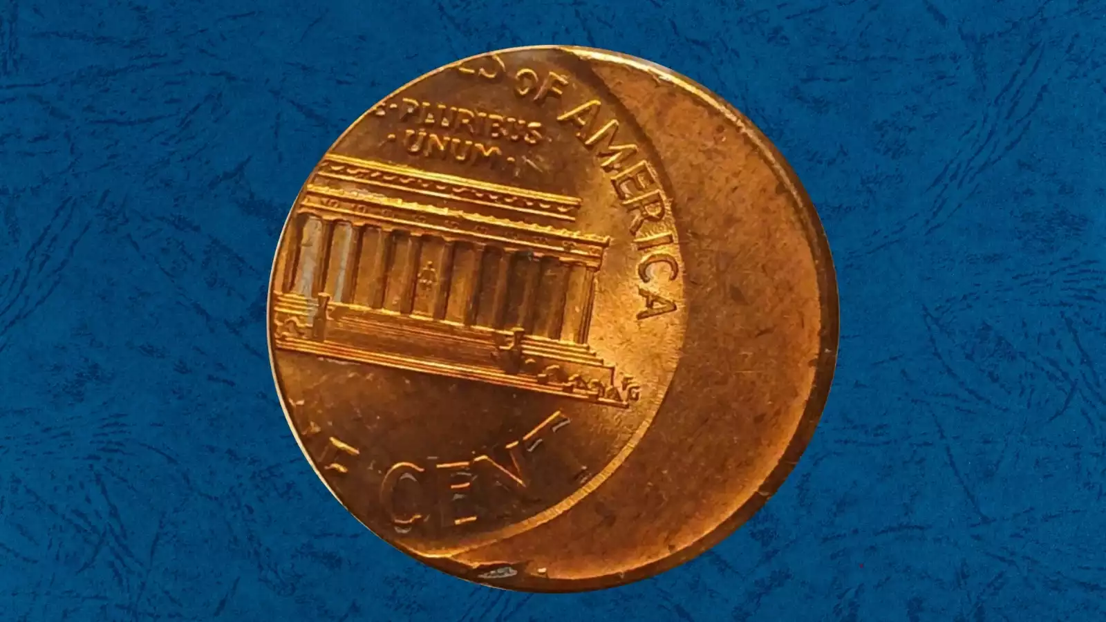 2002 Lincoln penny off-center strike error showing design shifted approximately 35-40% off center with date visible